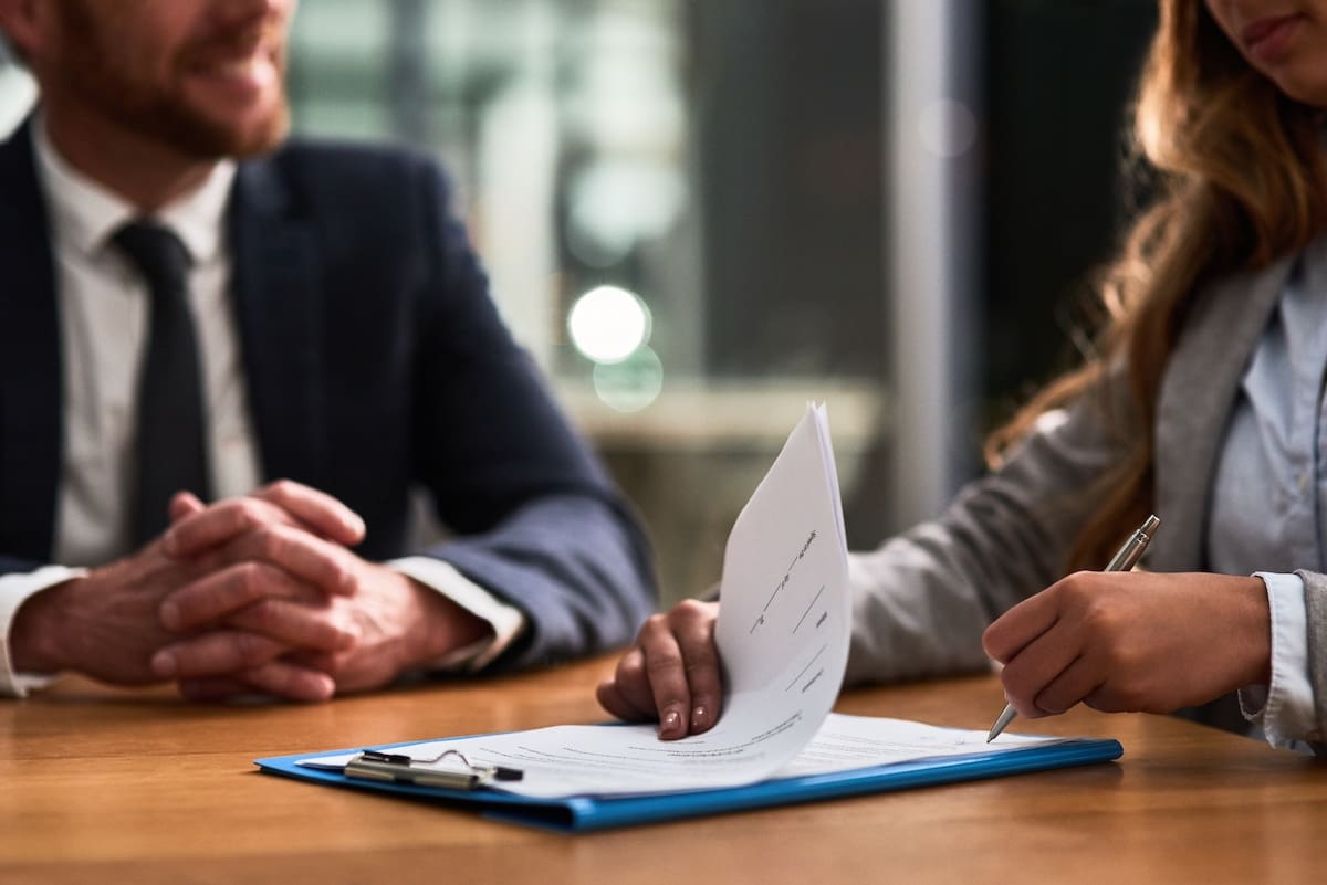 two people reviewing lease document two people reviewing lease document