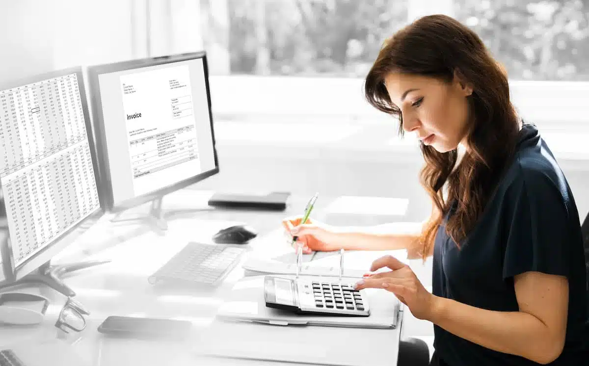 woman executing the stages of the accounting cycle