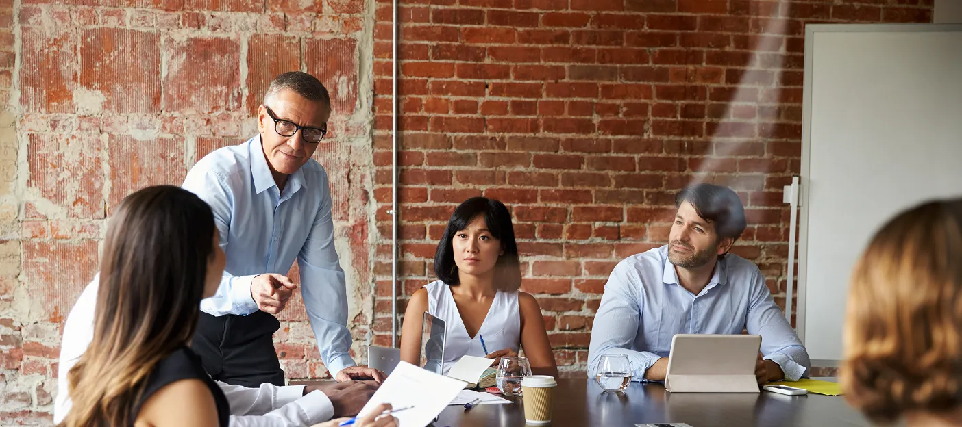 Partner Access 4 older man leading meeting