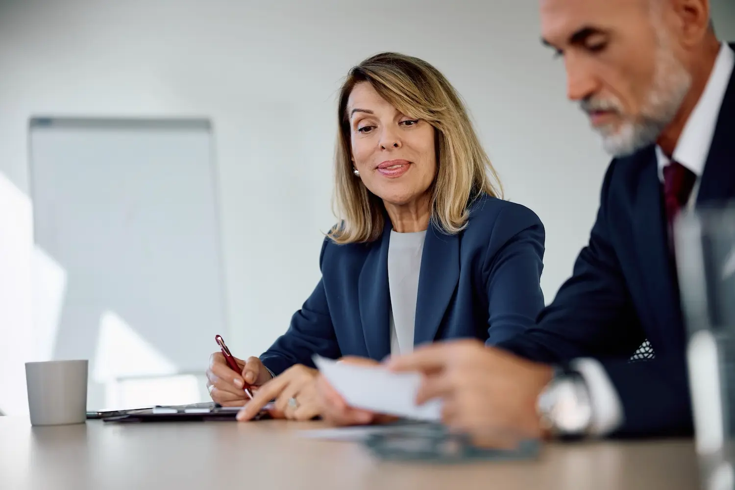 What Is an S Corp and When Should Your Business Make the Switch? 2 Small business owner discusses with her tax advisor the process for switching her company to an S corporation