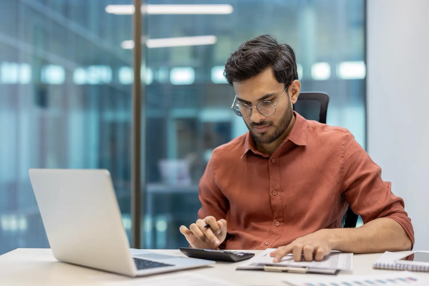 An accountant reviews his accumulated depreciation calculations