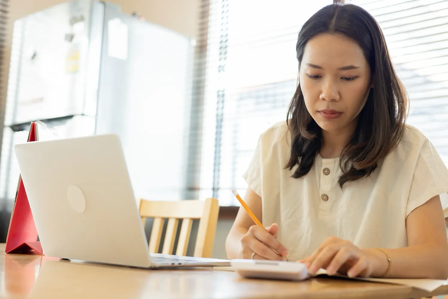 A woman calculates her tax liability